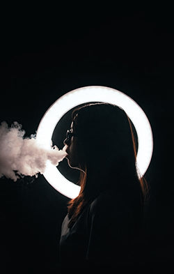Vaping Model model vaping in front of LED ring